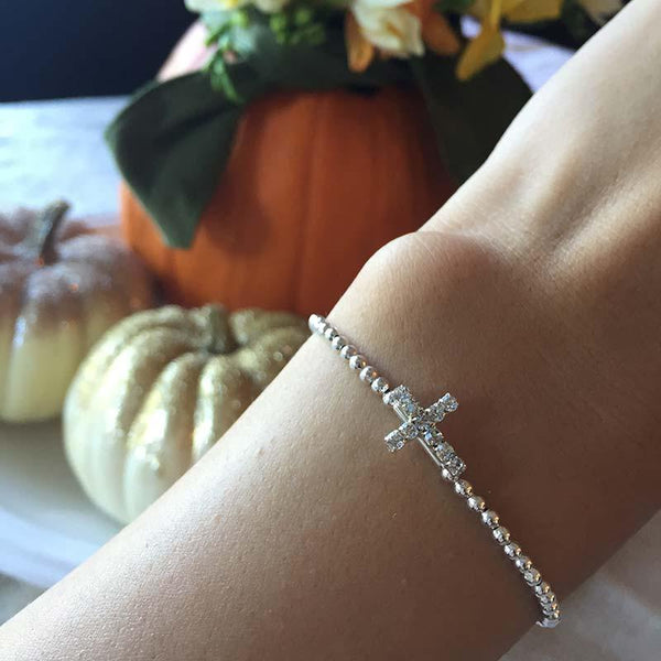 Tiny shop cross bracelet